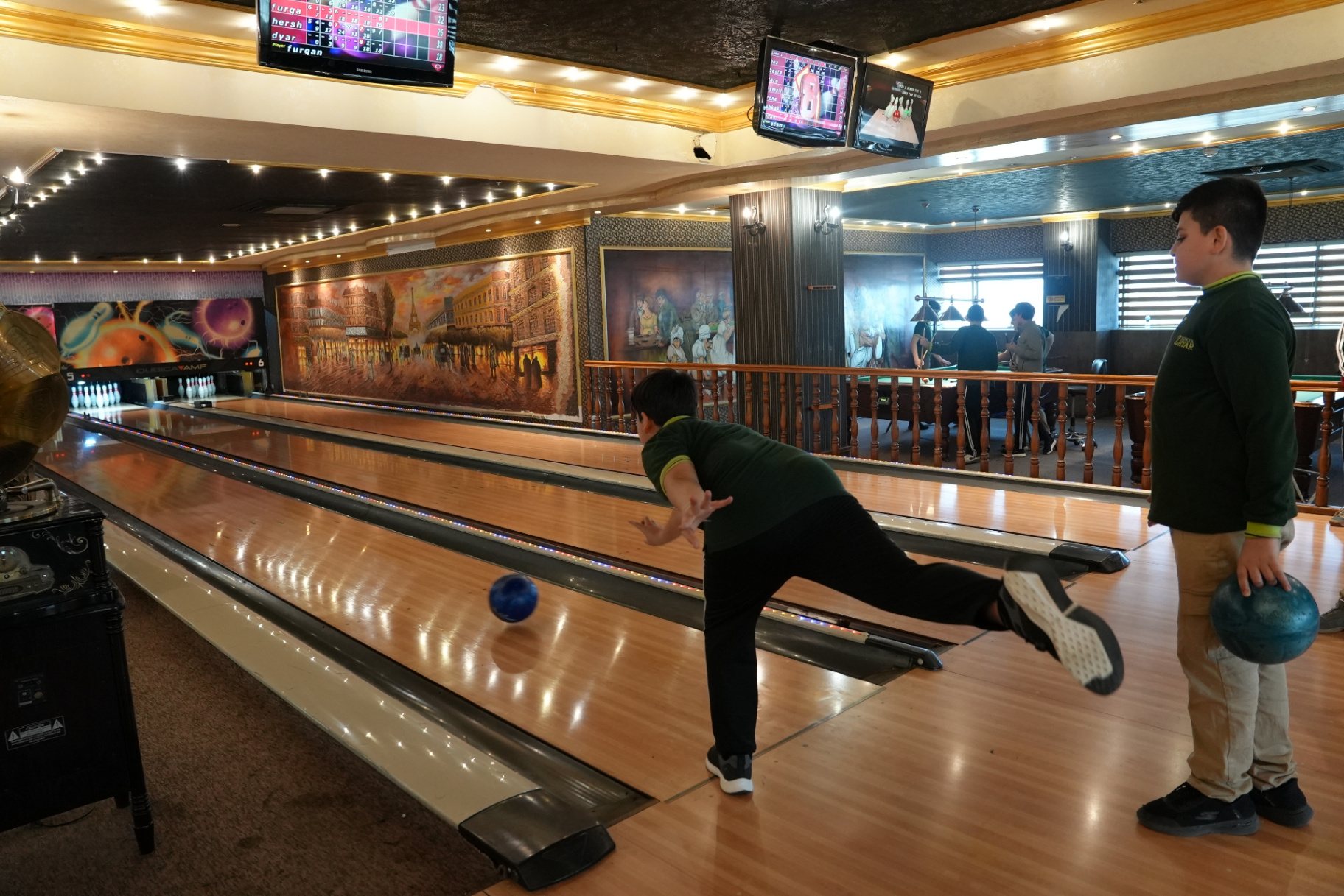Zhyar students bowling together on a class trip to a local bowling alley