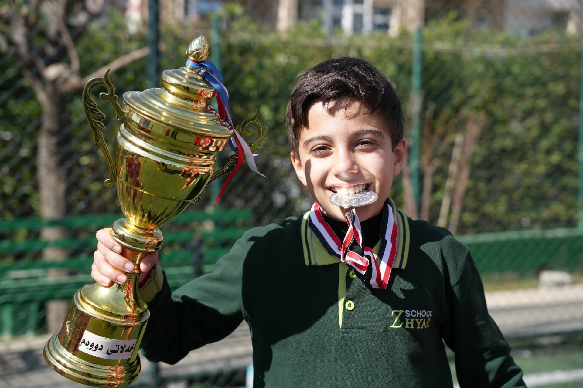 Boys racing and cheering on teammates during the annual school sports day