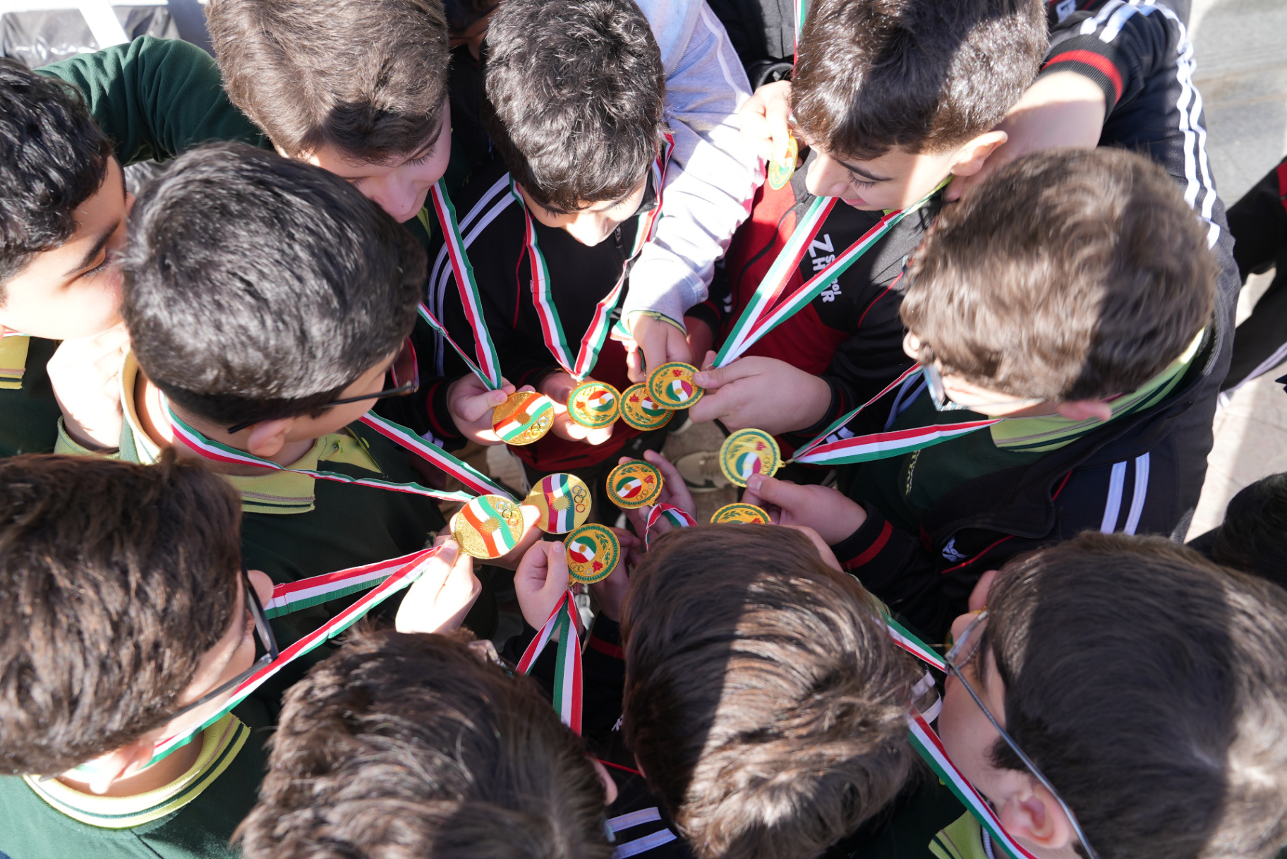 Boys competing in track and field events at the school Olympic Games