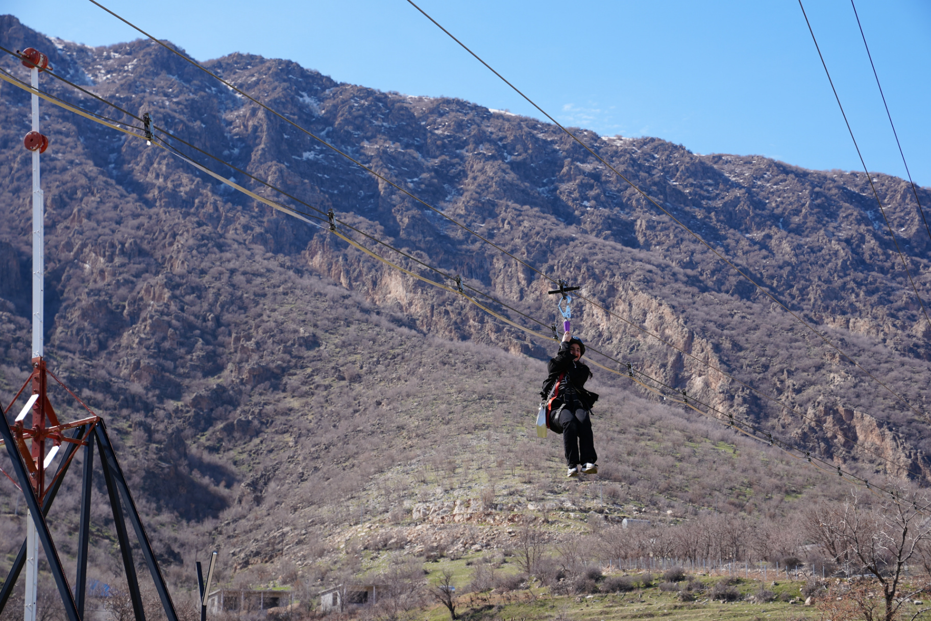 A student riding the zipline during the girls outdoor adventure challenge