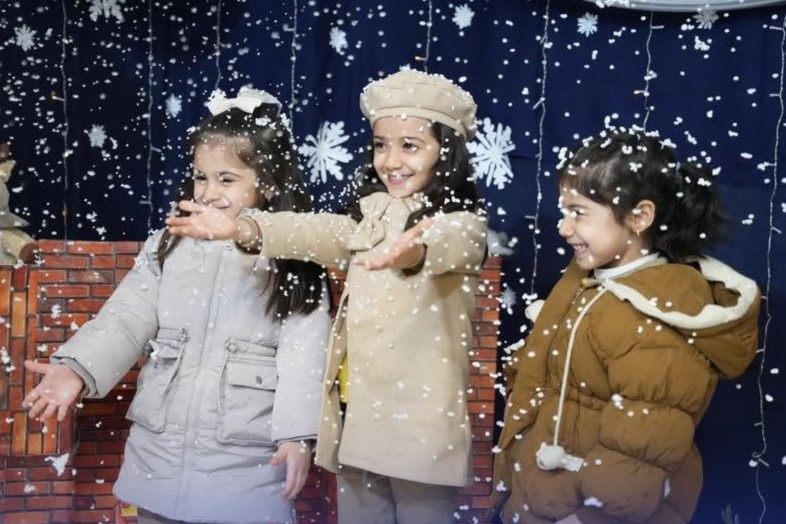 Students playing in the snow in the school grounds on a rare snowy morning in Erbil
