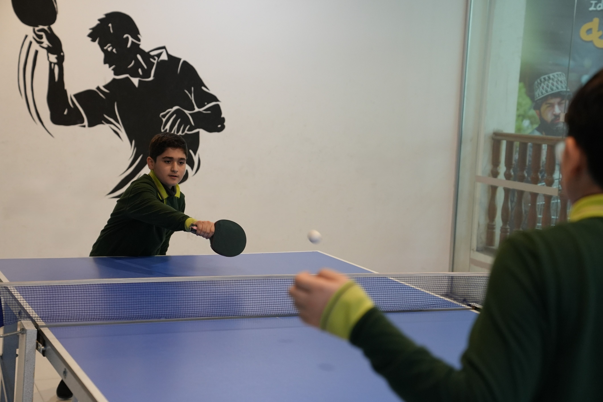 Students playing a tennis match during the school tennis tournament