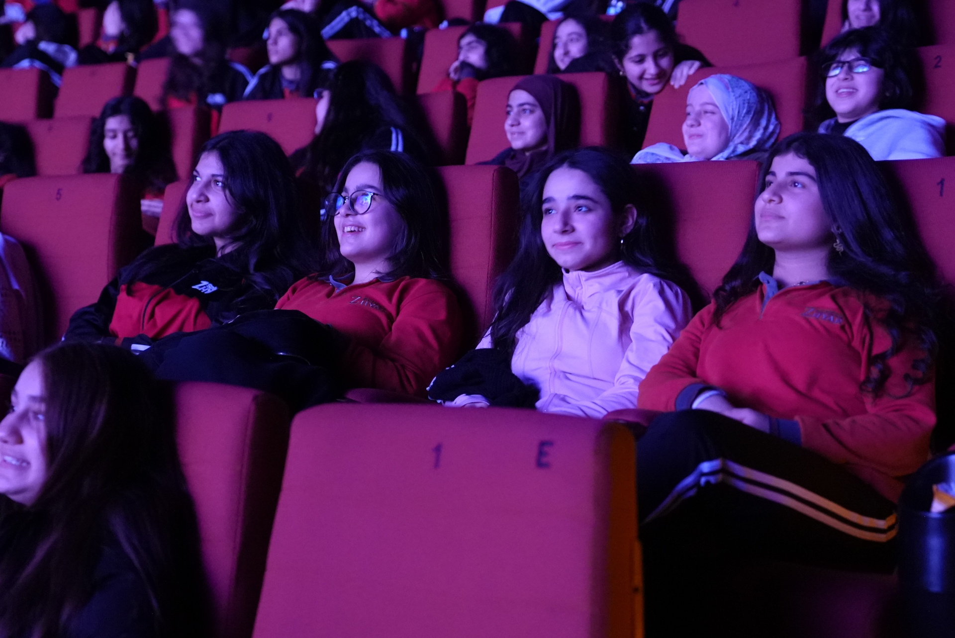 Girls arriving at the cinema together for a school film trip