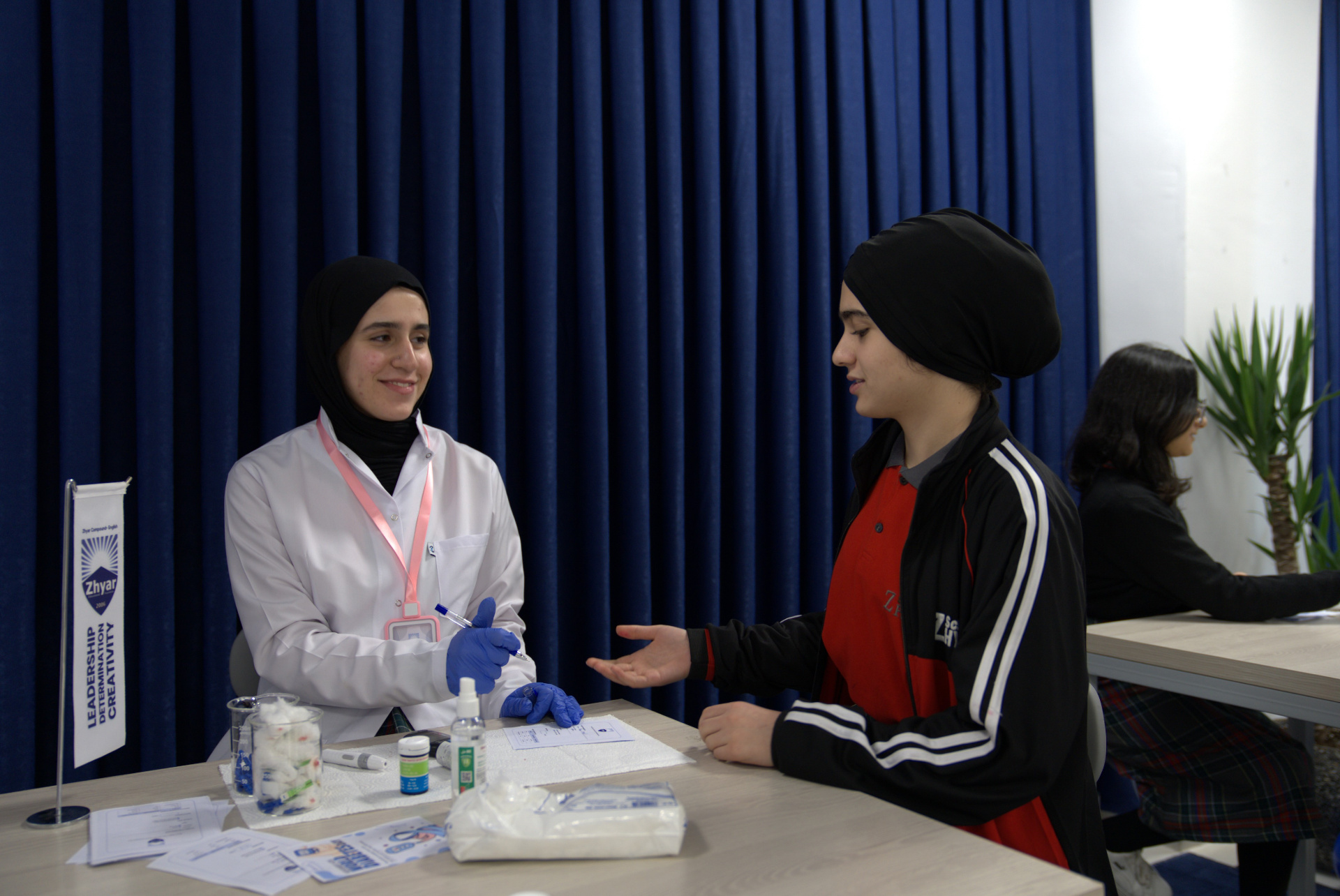 A nurse carrying out free diabetes screening for students and staff at the school clinic day