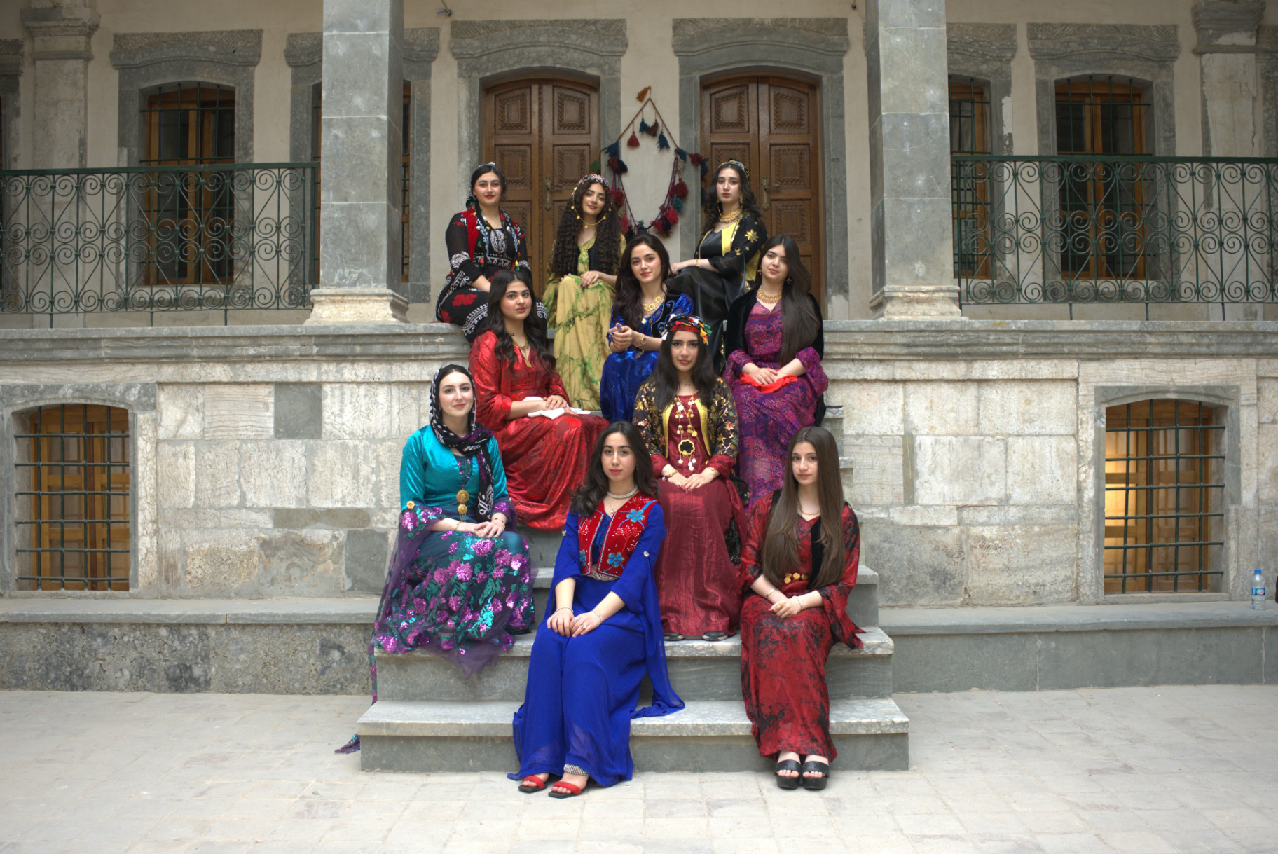Girls in traditional Kurdish dress celebrating Kurdish Flag Day at school